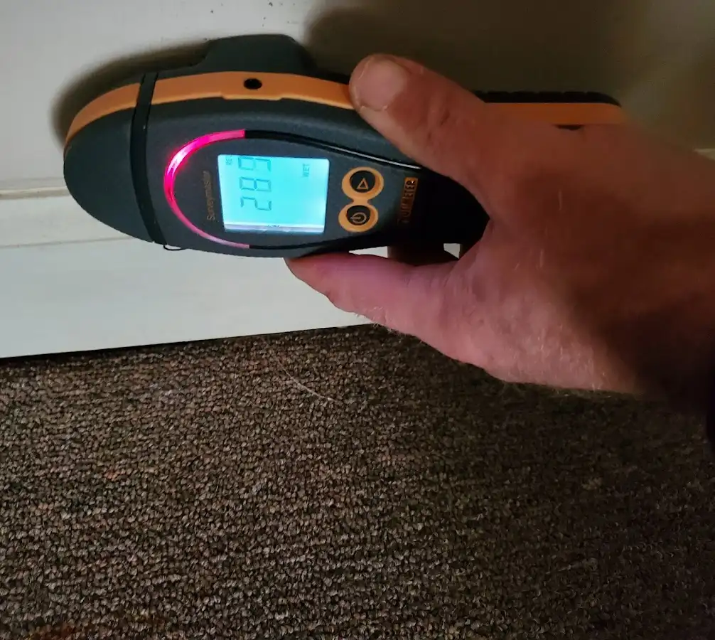 Moisture detection at baseboard during Storm Damage Restoration in Buda